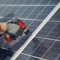 Engineer in a white helmet. Man near solar panel.